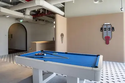 a pool table in a room with a mask on the wall at Business-Ready Executive Studio with Burj View in Dubai