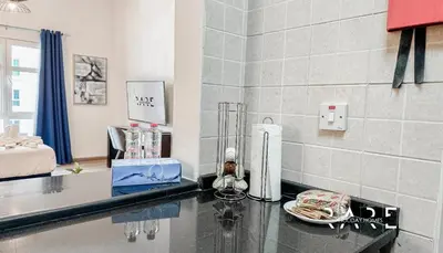 a kitchen with a counter top in a room at Rare Holiday Homes - Mediterranean Cluster - Near Ibn Battuta Mall - Discovery Garden - Building# Med 49 - R213 in Dubai