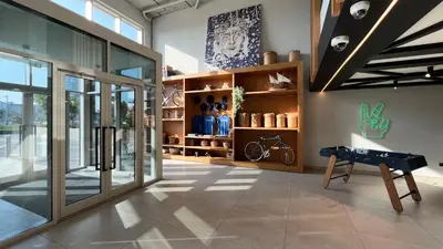 a room with a table in the middle of a building at Cozy 1BR Near Dubai Hills Park in Dubai