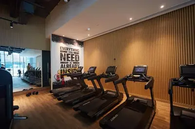 a gym with a group of treadmills and a sign at Comfy stylish studio on the Palm in Dubai