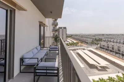 a balcony with chairs and a view of the city at Bespoke Holiday Homes - Mag Eye Residence in Dubai