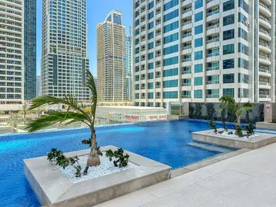 a swimming pool in a city with tall buildings at Stylish 1 BR Apartment close to JBR Beach in Dubai