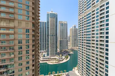 a view of a city from between two tall buildings at Stylish 1 BR Apartment close to JBR Beach in Dubai