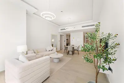 a living room with a couch and a table at Stylish 1 BR Apartment close to JBR Beach in Dubai