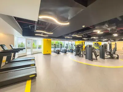 a gym with treadmills and machines in a room at Elegant 1 BR Apartment near Mall of the Emirates in Dubai