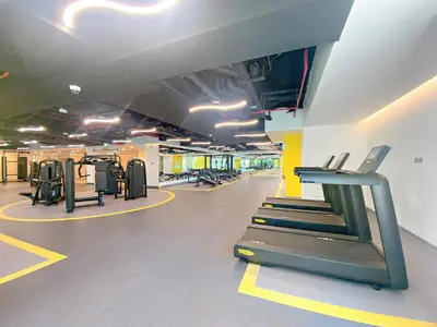 a gym with a treadmill and treadles in a room at Elegant 1 BR Apartment near Mall of the Emirates in Dubai