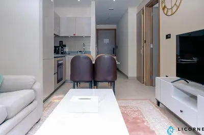 a living room with a couch and a table at Luxury One BR in Sobha Hartland in Dubai