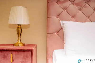 a bedroom with a bed and a lamp on a table at Luxury One BR in Sobha Hartland in Dubai