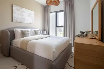 a bedroom with a large bed and a window at Frank Porter - La Rosa 6 in Dubai
