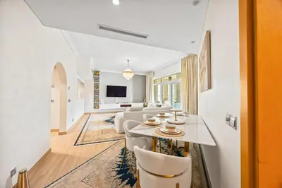 a living room with a table and chairs at 2BDR Luxury Apartment in Palm in Dubai