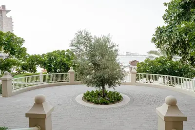 a tree in a circle in the middle of a walkway at 2BDR Luxury Apartment in Palm in Dubai