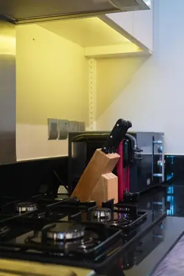 a kitchen stove with a knife on top of it at Luxurious Studio in Heart of Business Bay in Dubai