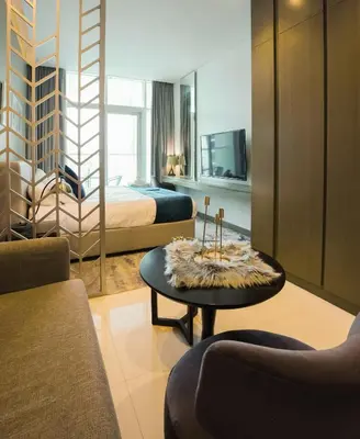 a hotel room with a bed and a coffee table at Luxurious Studio in Heart of Business Bay in Dubai