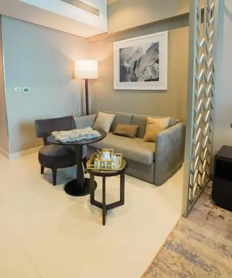 a living room with a couch and a table at Luxurious Studio in Heart of Business Bay in Dubai