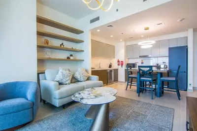 a living room with a couch and a table at Forte, Downtown- Elegant 1-BR in Dubai