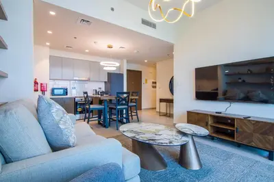 a living room with a couch and a table at Forte, Downtown- Elegant 1-BR in Dubai