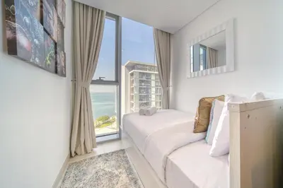 a bedroom with a bed and a large window at Shadow Of The Sun by Lagom in Dubai