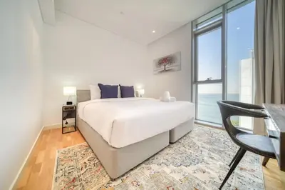a bedroom with a large bed and a large window at Shadow Of The Sun by Lagom in Dubai