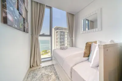 a bedroom with a bed and a large window at Shadow Of The Sun by Lagom in Dubai