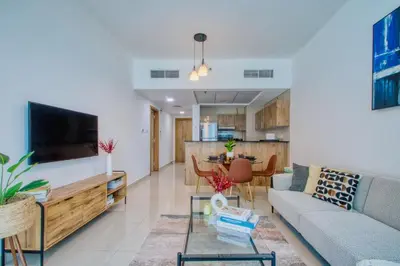 a living room with a couch and a table at ShoresInn - Charming 1BR with Marina Views in Dubai