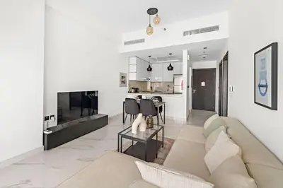 a living room with a couch and a table at Amazing 1 Bdr luxury residence Dubai Arjan in Dubai