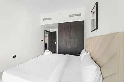 a bedroom with a large white bed with white pillows at Amazing 1 Bdr luxury residence Dubai Arjan in Dubai