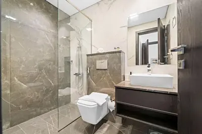 a bathroom with a shower and a toilet and a sink at Amazing 1 Bdr luxury residence Dubai Arjan in Dubai