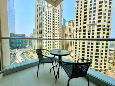 a table and two chairs on a balcony with a view at Amazing 1BR in Dubai Marina with Luxury Interiors in Dubai
