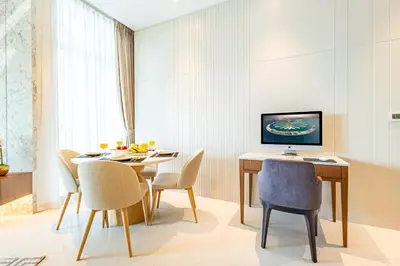 a dining room with a table and chairs at Deluxe One-Bedroom Apartment in Business Bay with Burj Khalifa and Canal View in Dubai