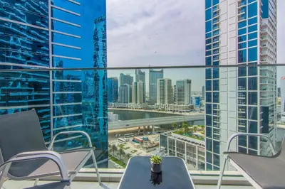 a balcony with chairs and a view of a city at Marquise Square Studio, Business Bay in Dubai