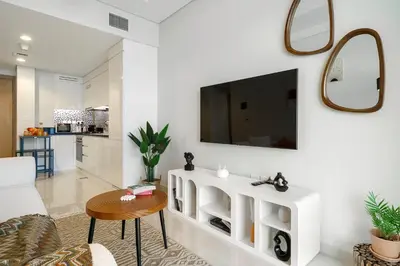 a living room with a tv on a white wall at DAYF-FSL 1-Bedroom in Business Bay near Downtown Dubai in Dubai