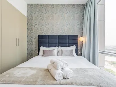 a bedroom with a large bed with towels on it at Prestigious 2BR-Noura Tower- Business Bay in Dubai