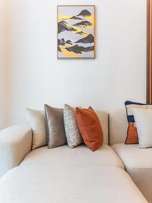 a white couch with pillows on top of it at Prestigious 2BR-Noura Tower- Business Bay in Dubai