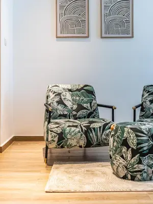 a living room with a chair and a rug at Prestigious 2BR-Noura Tower- Business Bay in Dubai
