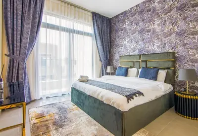 a bedroom with a large bed with a purple wall at Reem 3 BDR Villa in Dubai