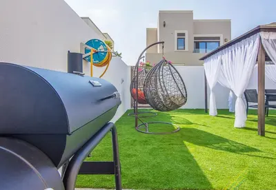 a backyard with a swing and a playground at Reem 3 BDR Villa in Dubai