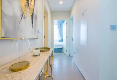 a bathroom with a counter with two sinks and a hallway at Reem 3 BDR Villa in Dubai