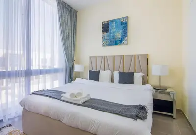 a bedroom with a large bed with two towels on it at Reem 3 BDR Villa in Dubai