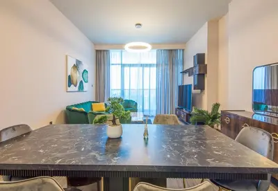 a living room with a large table and chairs at MBL Residence 2 BDR, JLT in Dubai