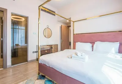 a bedroom with a large bed with towels on it at MBL Residence 2 BDR, JLT in Dubai