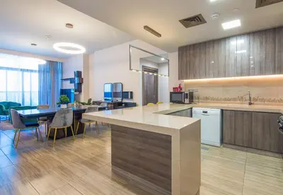 a large kitchen with a table and a dining room at MBL Residence 2 BDR, JLT in Dubai