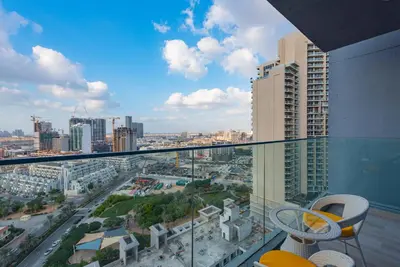 a view of a city from the balcony of a building at Bloom Heights 1 BR, JVC in Dubai