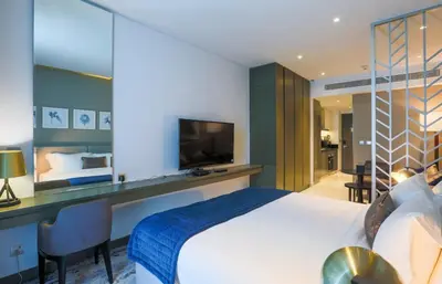 a hotel room with a bed and a television at Damac Maison Prive, Business Bay- Gorgeous Studio in Dubai