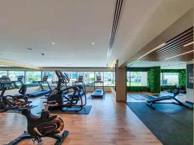 a gym with treadmills and cardio equipment in a building at Elite 1 BR, Downtown in Dubai