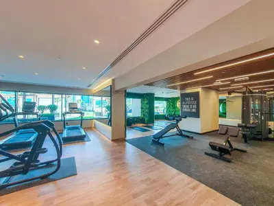 an exercise room with treadmills and elliptical machines at Elite 1 BR, Downtown in Dubai