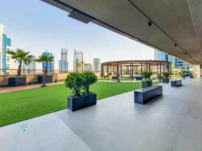 a view of a building with a lawn and a gazebo at Elite 1 BR, Downtown in Dubai