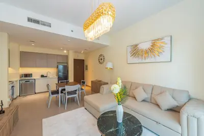a living room with a couch and a table at Park Heights 1 BR, Dubai Hills in Dubai