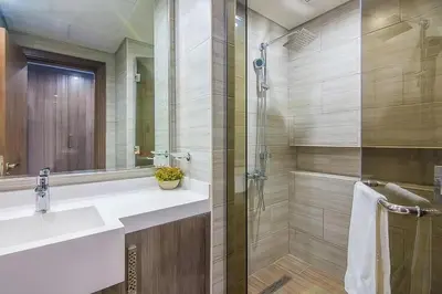a bathroom with a sink and a glass shower at MBL Residences 1 BR, JLT in Dubai