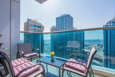 a balcony with chairs and a table with a view at MBL Residences 1 BR, JLT in Dubai