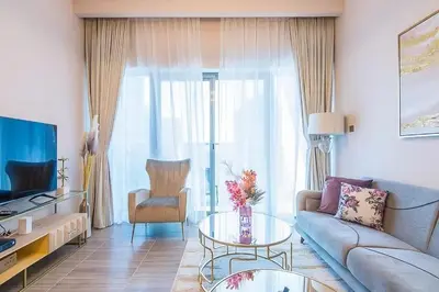 a living room with a couch and a table at MBL Residences 1 BR, JLT in Dubai